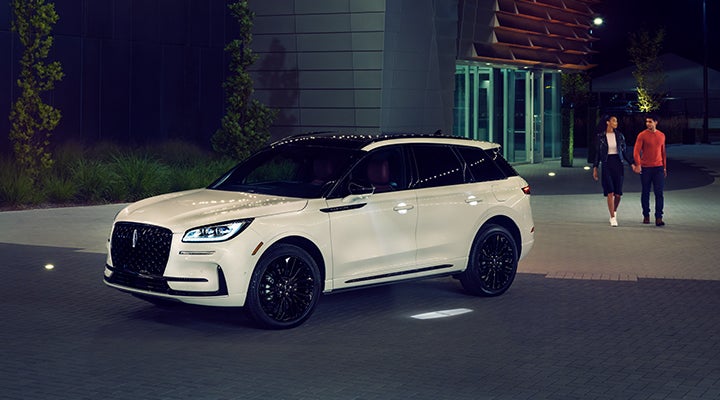 Two people approach a 2024 Lincoln Corsair® SUV featuring the available Jet Appearance Package. | Ted Britt Chantilly Lincoln in Chantilly VA