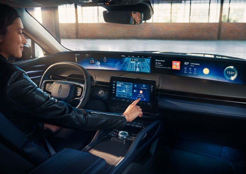 The driver of a 2024 Lincoln Nautilus® SUV interacts with the center touchscreen. | Ted Britt Chantilly Lincoln in Chantilly VA