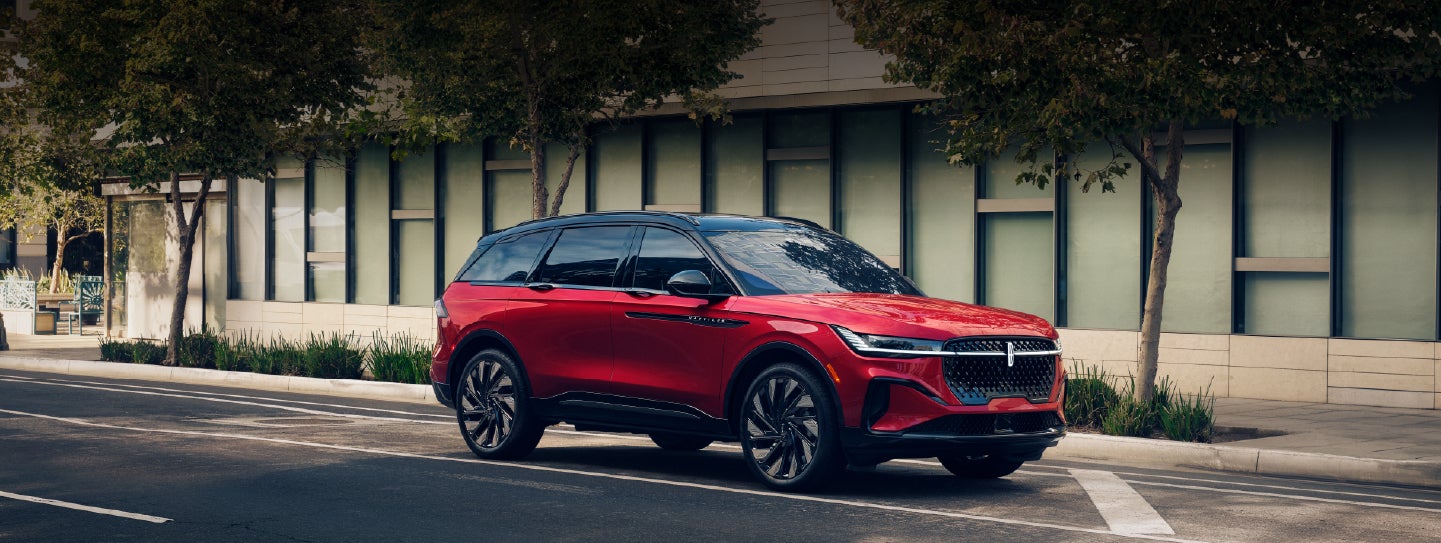 A 2025 Lincoln Nautilus® SUV with an available hybrid powertrain is parked in an urban setting. | Ted Britt Chantilly Lincoln in Chantilly VA