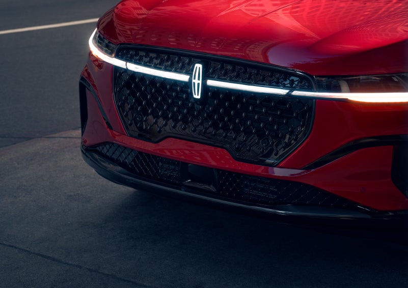 The available front LED light bar and center Lincoln Star logo glow at dusk. | Ted Britt Chantilly Lincoln in Chantilly VA