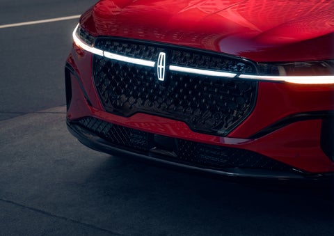 The available front LED light bar and center Lincoln Star logo glow at dusk. | Ted Britt Chantilly Lincoln in Chantilly VA