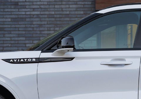 The driver’s side door and fender badging of a white 2026 Lincoln Aviator® SUV are showcased. | Ted Britt Chantilly Lincoln in Chantilly VA