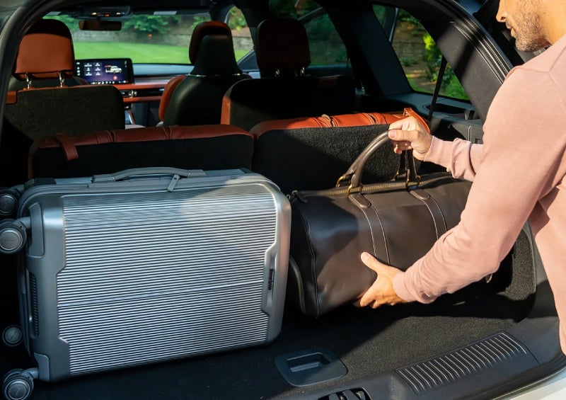 A man loads luggage into the rear of a 2026 Lincoln Aviator® SUV through the opened rear liftgate. | Ted Britt Chantilly Lincoln in Chantilly VA