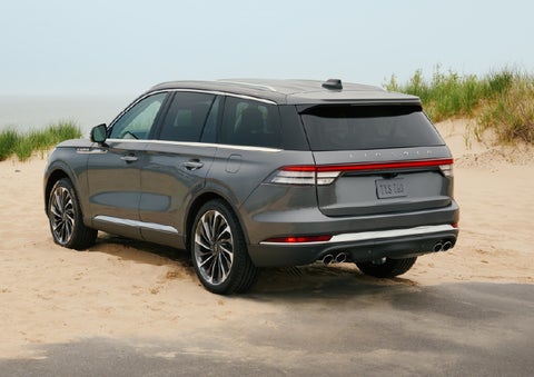A 2027 Lincoln Aviator® SUV is parked next to sand dunes. | Ted Britt Chantilly Lincoln in Chantilly VA