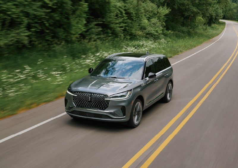 A 2027 Lincoln Aviator® SUV is being driven down a road. | Ted Britt Chantilly Lincoln in Chantilly VA