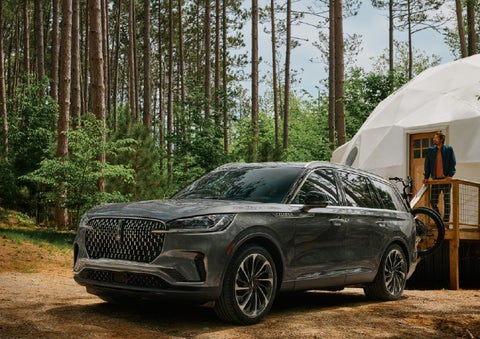 A 2027 Lincoln Aviator® is parked next to a high end glamping site. | Ted Britt Chantilly Lincoln in Chantilly VA