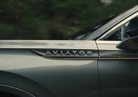 The driver’s side door and fender badging of a gray 2027 Lincoln Aviator® SUV are showcased. | Ted Britt Chantilly Lincoln in Chantilly VA