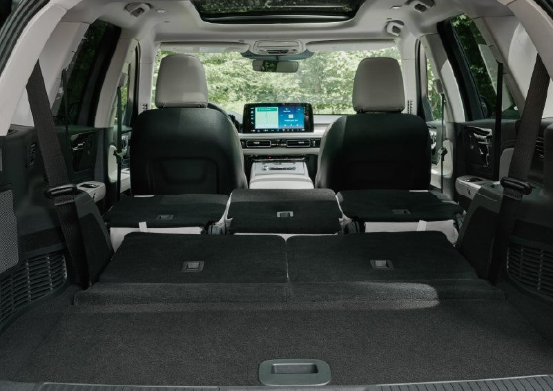 A rear to front view of the interior of a 2027 Lincoln Aviator® Black Label™ SUV shows the third and second rows folded flat | Ted Britt Chantilly Lincoln in Chantilly VA