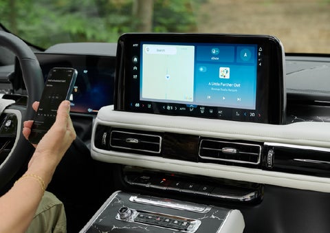A person pairs thier phone with the center touchscreen of a 2027 Lincoln Aviator® Black Label™ SUV | Ted Britt Chantilly Lincoln in Chantilly VA